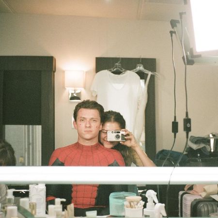 Tom Holland posing for a picture with Zendaya